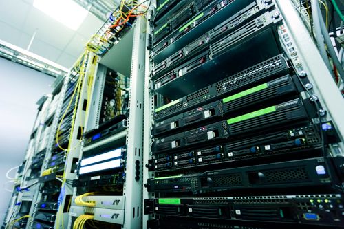 High-tech server rack in a secure data center with network cables and hardware components. Photo: Pexels.